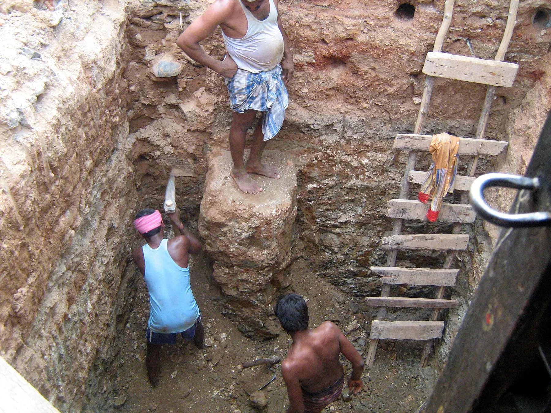 Workers digging a foundation pit